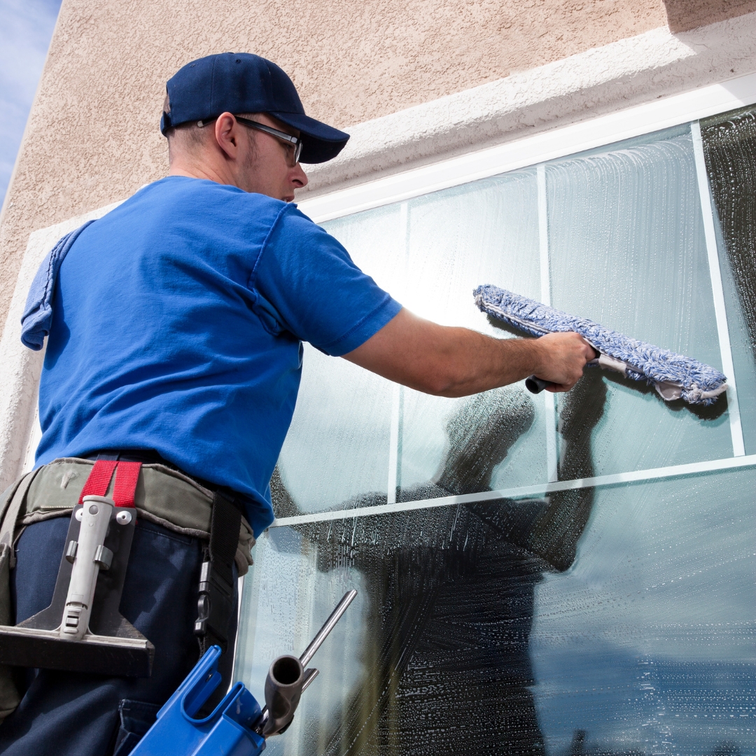 man cleaning window exterior